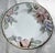Measuring approximately 10 1/4 inches, this lovely bowl features the distinctive Fleur Fantasia design with colorful peach...