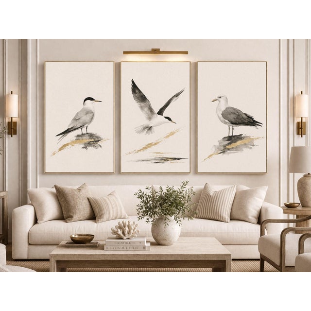 A refined trio of coastal seabird studies, each rendered in soft neutral tones with subtle watercolor texture and gold...