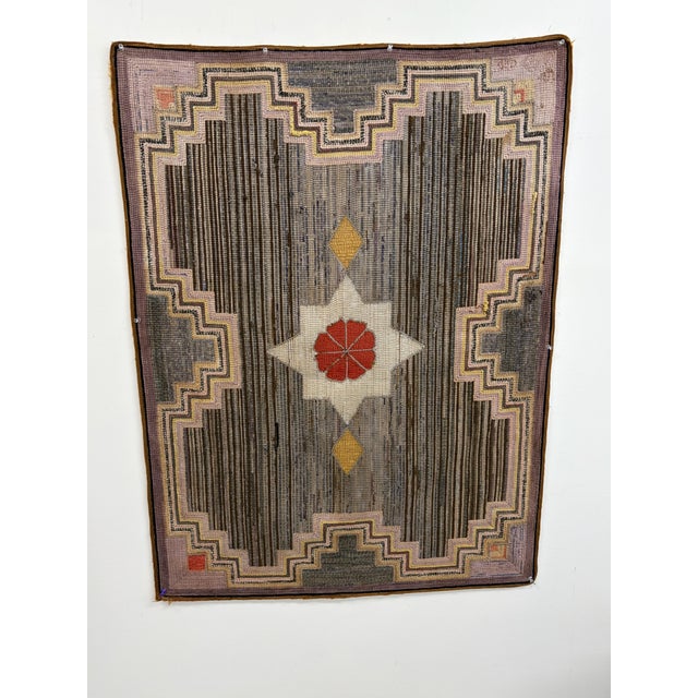 Vintage hand hooked rug with a geometric Southwestern-inspired design in gray, brown, cream, muted purple, red, and...