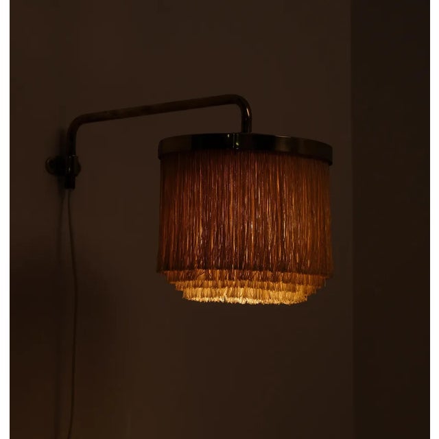 Swedish wall light with fringes model V-267 designed by Hans-Agne Jakobsson, produced in Markaryd, Sweden, 1960s. This...