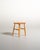 Scandinavian-made birch stool from the 1950s, featuring a square top with rounded corners, slightly splayed legs, and...