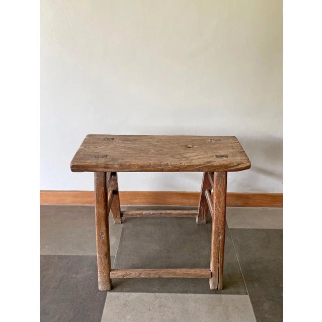 This antique elm wood stool comes from China's Hubei province. It was crafted using only wooden joints. The elm wood has...