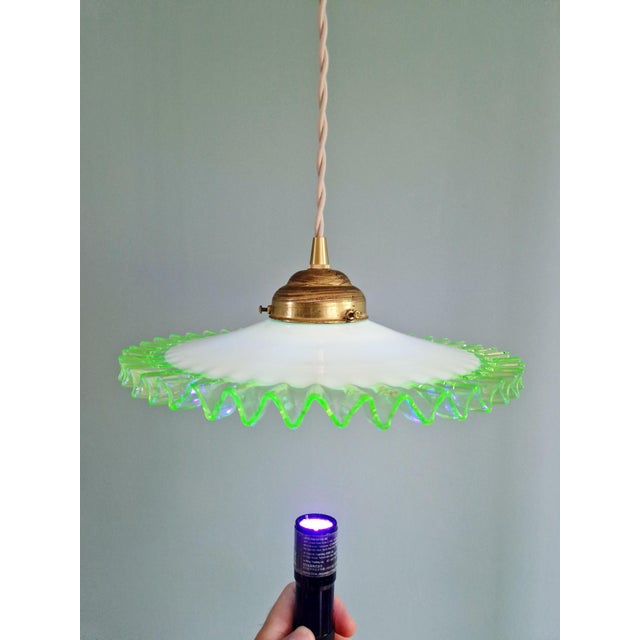 Art Deco pendant light in white opaline glass with scalloped uranium glass edges, France, 1920s-30s. Original brass claw...