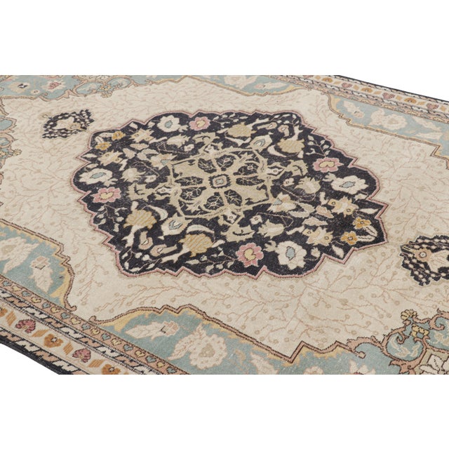 Hand-knotted in wool, this 7x10 vintage rug originating from Turkey, circa 1950-1960, is a very special piece, featuring a...