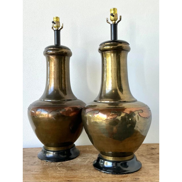 This striking pair of vintage table lamps is a masterclass in Hollywood Regency glamour and mid-century architectural...