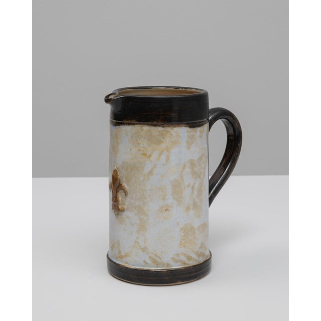 20th Century German ceramic vase. This handcrafted ceramic piece features a cylindrical form with a pronounced spout and...