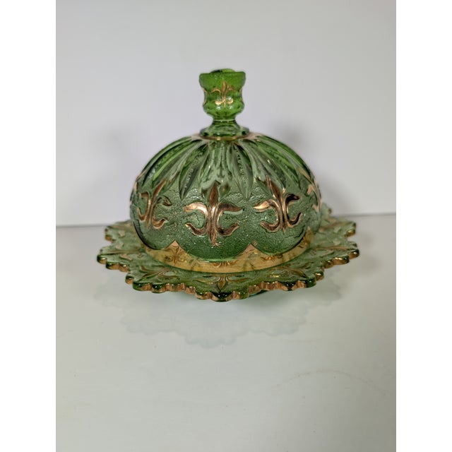 This very rare Jefferson Glass green glass covered butter dish is from 1903. The dish features an Iris and Meander pattern...