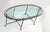 Hollywood Regency Mastercraft brass coffee table with hoof feed & thick classical racetrack glass top. The base shows a...