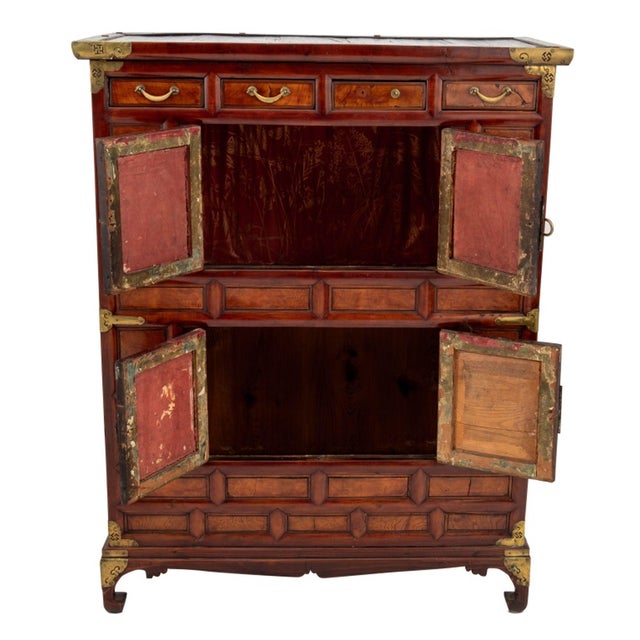 Korean Brass Mounted Elm Chest on Chest, with four short drawers above two sets of two doors opening to storage...
