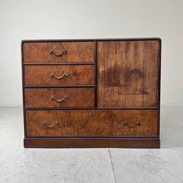 Japanese cabinet with four beautiful veneered drawers and a storage area subdivided with a shelf. This 1930s tansu is...