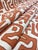 58" wide Robert Allen Kasai Cloth Henna African abstract upholstery fabric in rusty brown and ivory. Price is per yard.