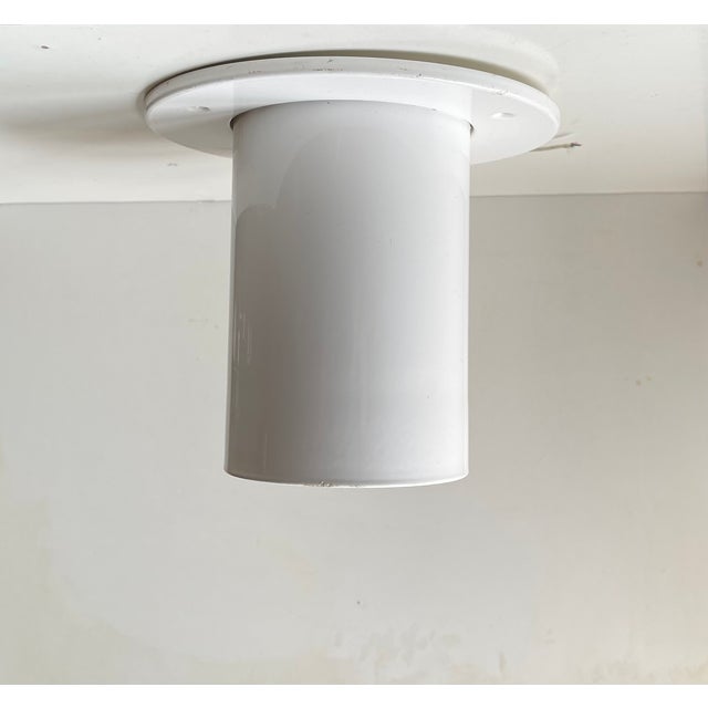 White built-on ceiling light or flush mount in powder coated metal. This design inspired by Gino Sarfatti was created by...