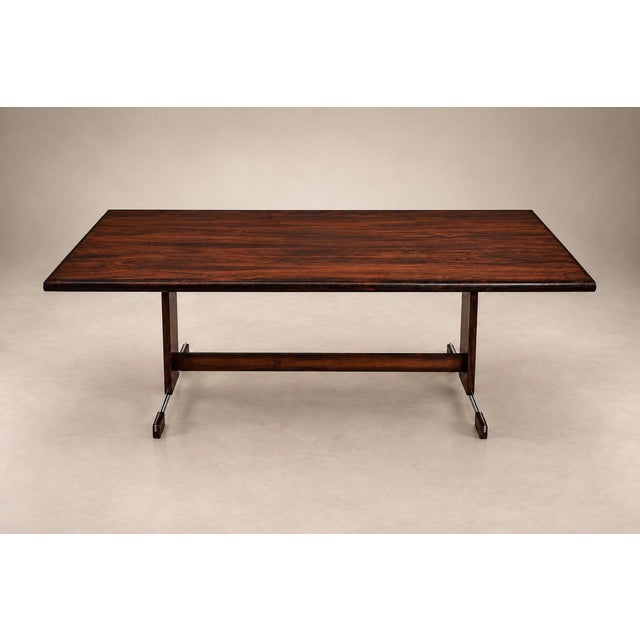 A generously proportioned Brazilian modern dining table attributed to Jorge Zalszupin. The expansive rosewood top reveals...