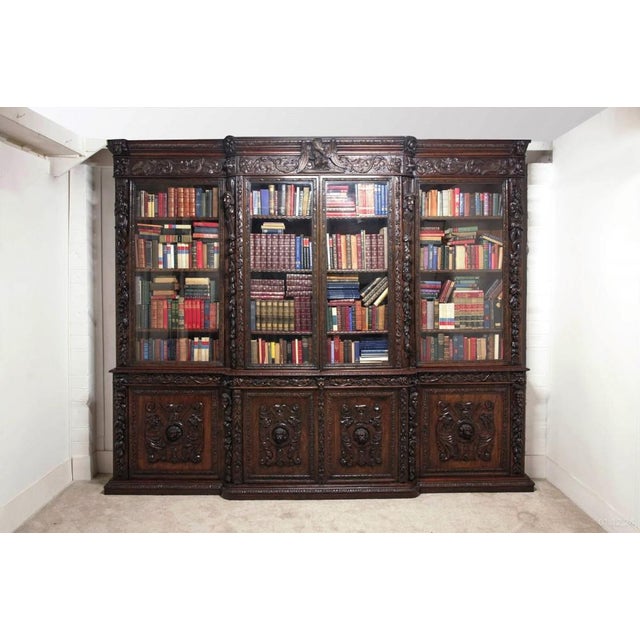 You are viewing a gorgeous monumental carved victorian library bookcase of breakfront form the bookcase is circa 1870 and...