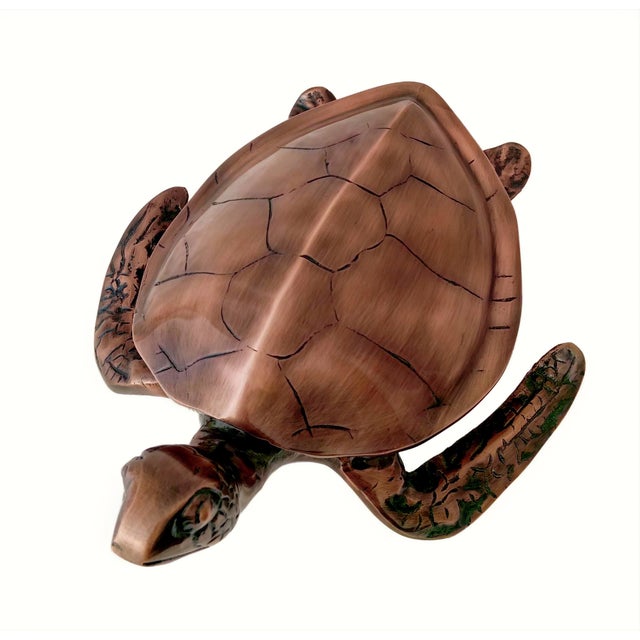 Upgrade your home décor with this striking antique-style sea turtle sculpture, expertly crafted from real metal and...