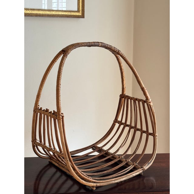 Offering a classic Franco Albini-style bentwood and rattan magazine rack from the mid-20th century. This lovely piece is...