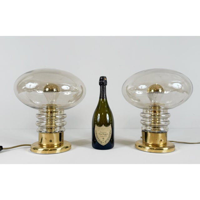 Mid-century set of two lamps/mushroom lamps, 1970s, constructed of glass and metal in a gold color, one light source...