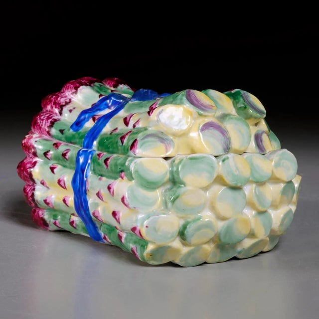 A bundle of asparagus that will never go limp: a German porcelain box and cover of about 1775, modeled as fat spears tied...