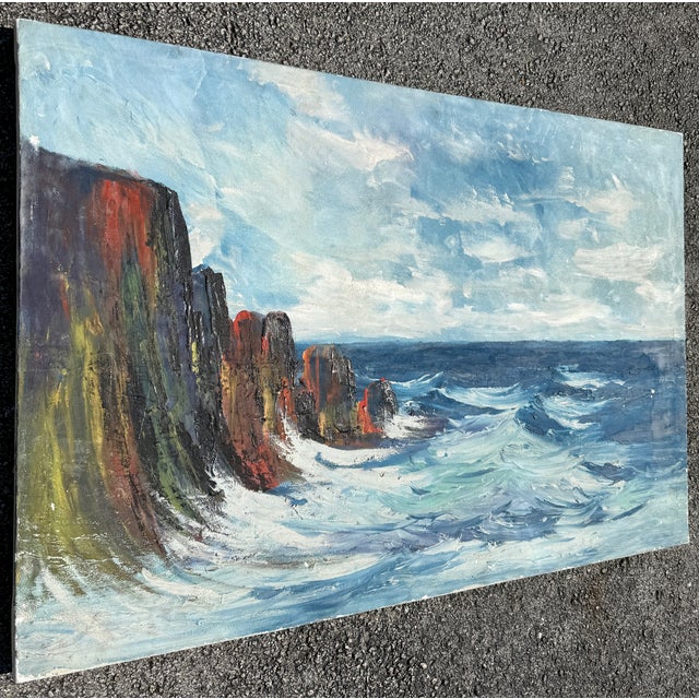 Original seascape oil painting on canvas depicting a dramatic cliff landscape with a turbulent ocean. Circa 1950....