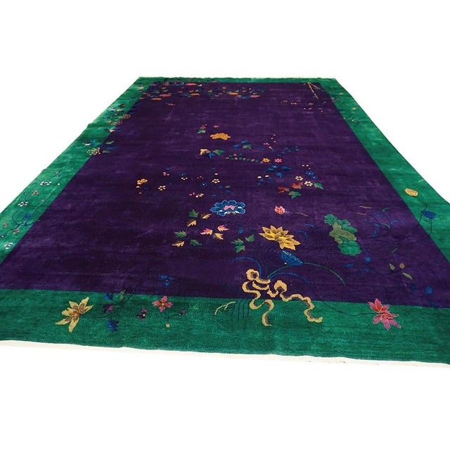 1920s Purple Floral Large Wool Hand Knotted Pile Antique Rectangle Rug, Circa Date: 1920s. This exceptional piece captures...