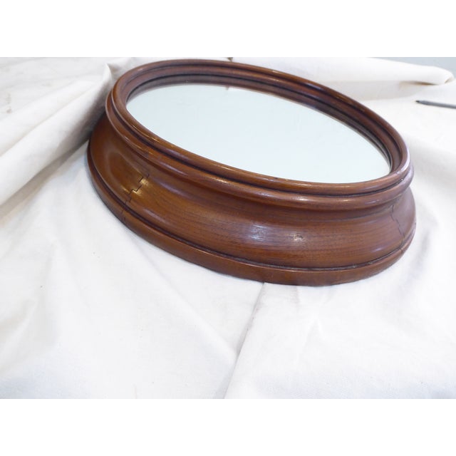 This Walnut oval mirror measures 15.5"H x 14.75"W and is 3.5"Deep.