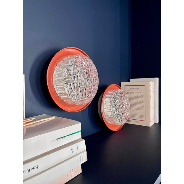 Pair of clear cut glass wall sconces. Removable orange metal ring. In excellent condition. 1960s/70s. New electrical...