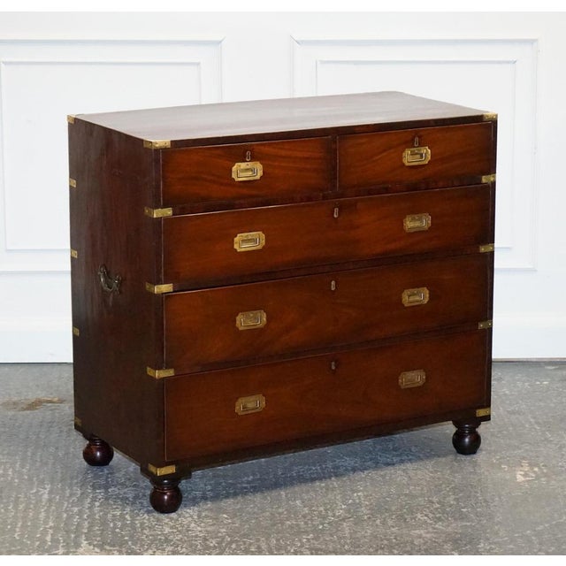 Antique Victorian Military Campaign Chest of Graduated Drawers is a remarkable piece of furniture that embodies both...
