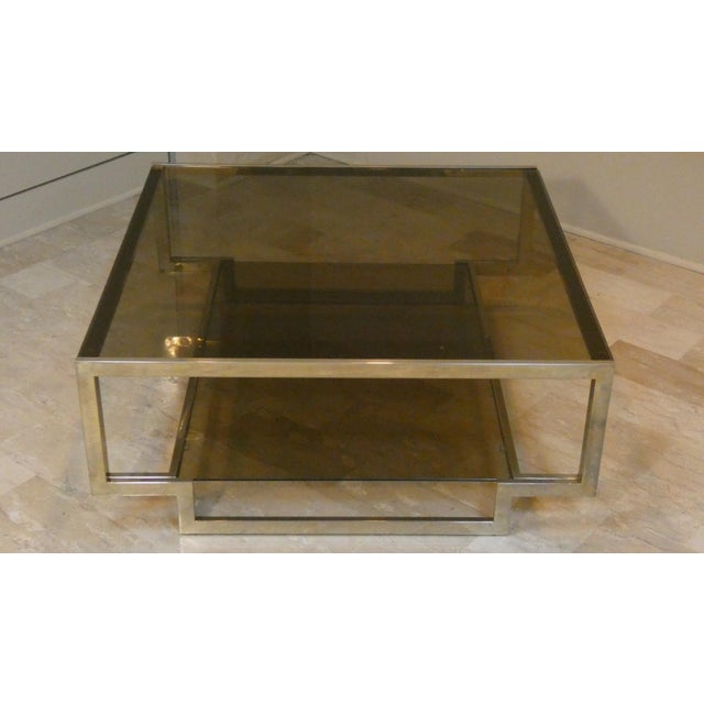 Vintage center table. A modern work of art, with two amber-colored glass shelves.