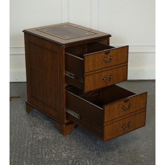 Vintage Oak Office Filing Cabinet with Two Drawers and Brown Leather Top. A classic and timeless piece of furniture that...