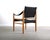 Stately safari chair in warm blonde wood and contrasting black upholstery. Sling style brings intrigue and comfort into...