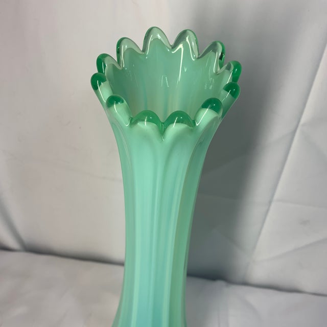 Offered here is a vintage mid-century green opalescent ribbed swung glass vase, from the Fostoria Heirloom line. This item...