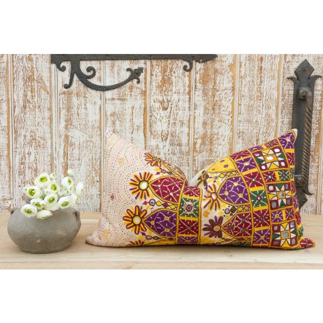 These colorful throw pillows are made from Rabari tribal dowry bags. The embroidery is on cotton and has intricate chain...