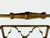 A distinctive vintage Hollywood Regency wine rack featuring an intricate quatrefoil fretwork design and a warm antique-...
