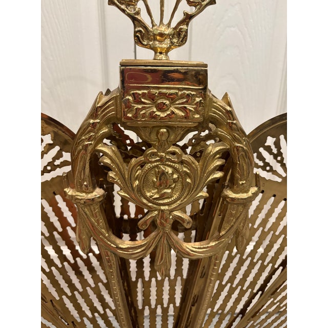 This brass folding peacock fan fireplace screen adds a touch of class to any setting. It folds like a hand fan and is...