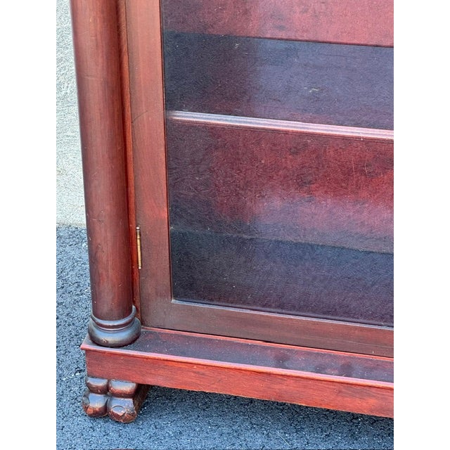 Handsome mahogany 2 door bookcase with claw feet and turned columns with carved capitals and leaded glass doors. Love the...