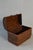 A small woven trunk with a hinged lid, original hardware and a warm, time-worn patina. Use it for storage on a bookshelf...