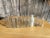A collection of 8 small one of a kind glass bottles. The clear class features beautiful and weathered patina from age....