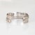 Stylish vintage Cartier cuff bracelet crafted in sterling silver and 18 karat yellow gold (circa 1964). The sculptural...