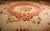This mid-19th-century European Aubusson rug is a 13' x 15' 8" hand-knotted wool piece showcasing refined French...