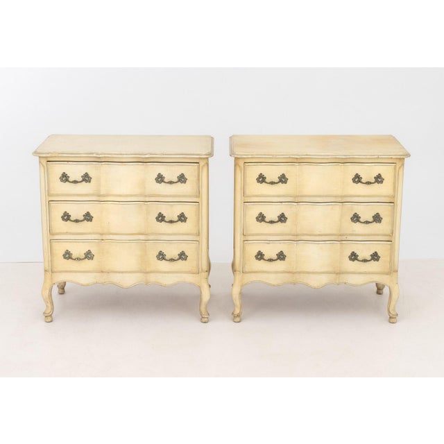 Pair of French Provincial Style Cream Painted Nightstands, each with three drawers on cabriole legs. 29.5" H x 29.25" W x...