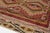 This is a vintage Turkish Oushak rug from the Mid 20th Century. The piece was hand-knotted.