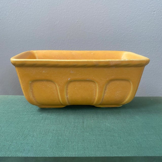 A light orange vintage ceramic planter. Would make beautiful shelf decor. Compliments green plant foliage nicely. Check my...