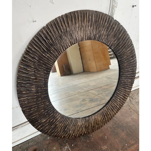 Large round mirror with a carved dark wood frame. 31.25"diameter