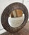 Large round mirror with a carved dark wood frame. 31.25"diameter