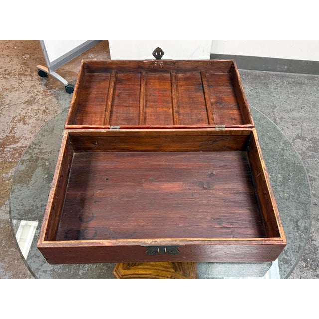 Design Plus Gallery presents a Vintage Red Lacquered Wood Storage Chest. The chest is detailed with engraved metal...