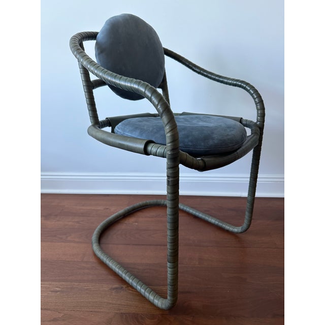 3 authentic, pre-loved Ochre Caribou chairs in a leather-wrapped cantilever design with snap-off removable back pads and...