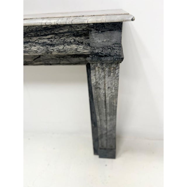 Napoleon iii style fireplace in "bleu turquin" marble two console-style jambs with recessed fluting very good condition...