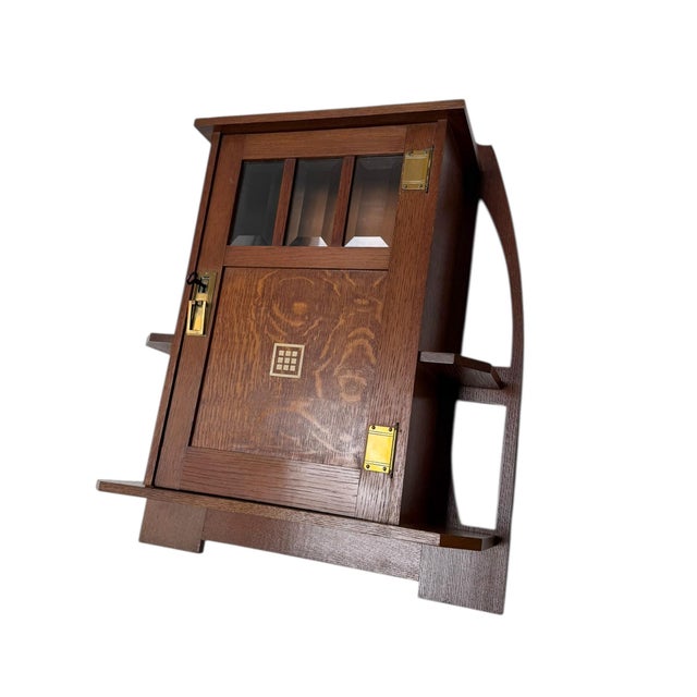 Magnificent and rare Arts & Crafts wall cabinet. Design by Onder den Sint Maarten. Solid oak frame with original beveled...