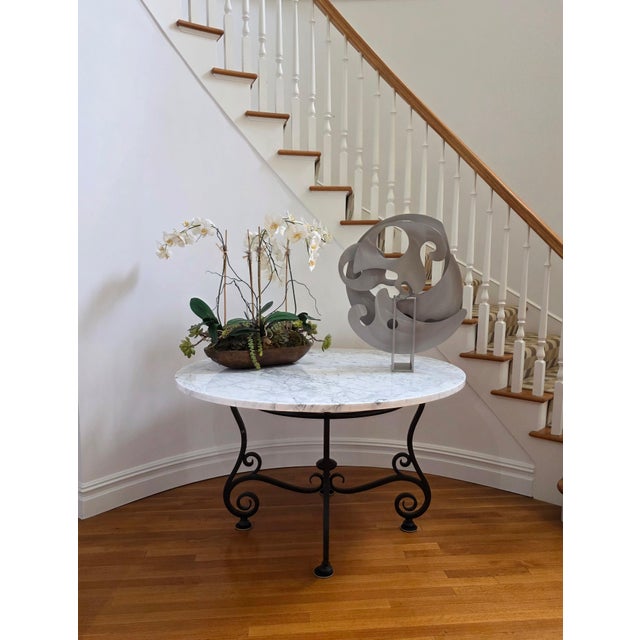 Large Impressive 54" round Carrara marble center table with a heavy rustic forged iron black scrolled base. Table height...