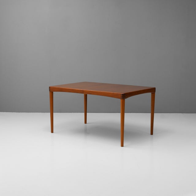 Extending mid-century dining table designed by Henry Walter Klein in 1950s Denmark, crafted by the skilled cabinetmakers...